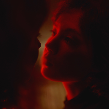 a pensive woman looking into her partner's eyes